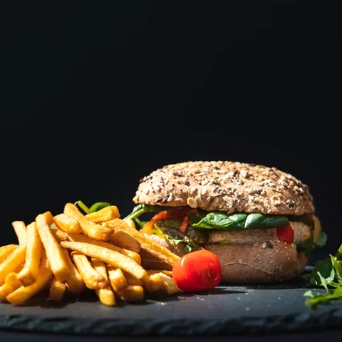 Burger and fries on a dark background