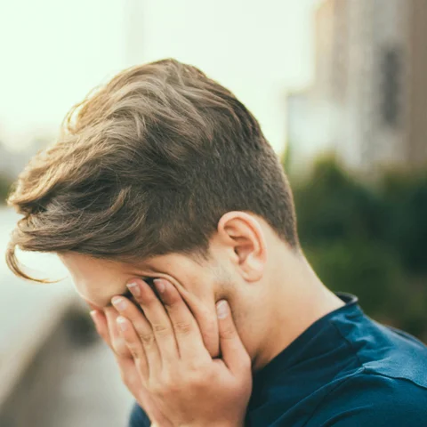 Tired person in a dark room